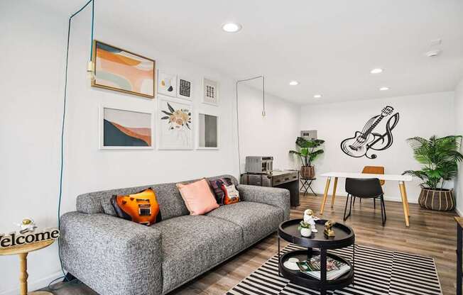 A living room with a grey couch and a coffee table.