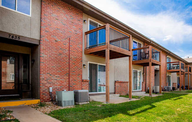 Apartment building with a balcony and air conditioning units.