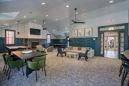 A large room with a dining table and chairs.