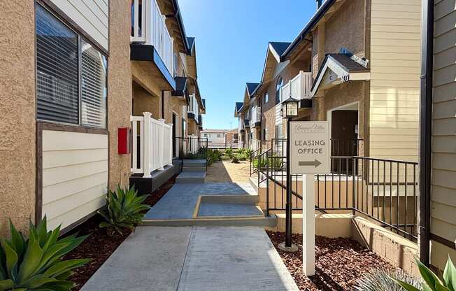 A leasing office is located in the middle of a row of houses.