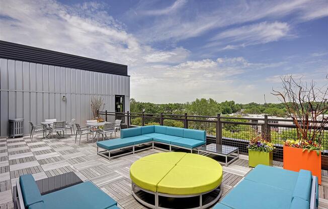 Be @ Axon Green Rooftop Patio and Sitting Area with couches, chairs, and tables