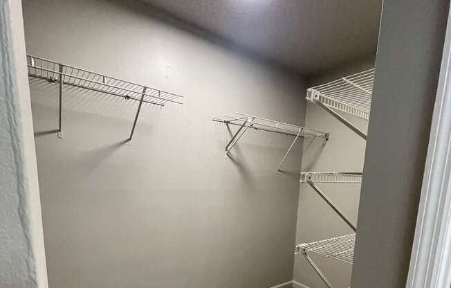 A white wall with a ladder in the corner.