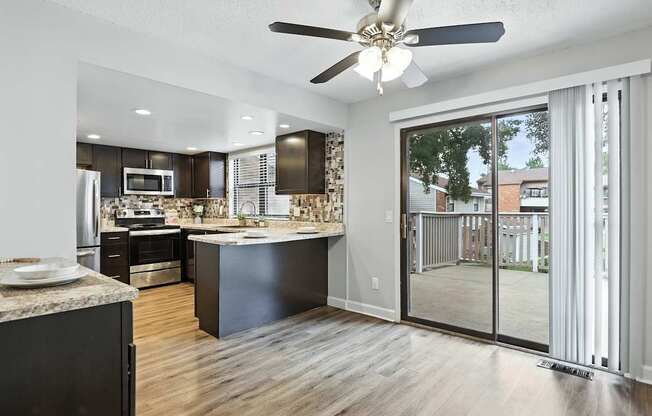 A modern kitchen with a large island and a view of the backyard.