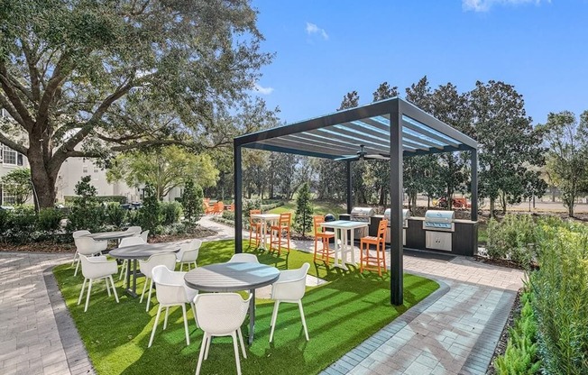 a patio with tables and chairs under a canopy