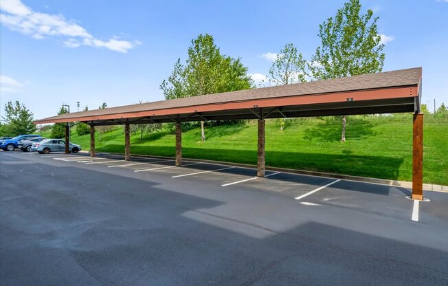 A parking lot with a long covered parking area.