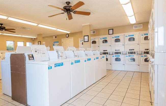 the laundry room at the enclave at woodbridge apartments in sugar land, tx