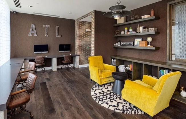 A living room with a yellow chair and a black and white rug.
