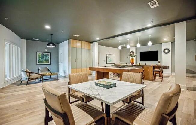 A modern dining room with a large table and chairs.