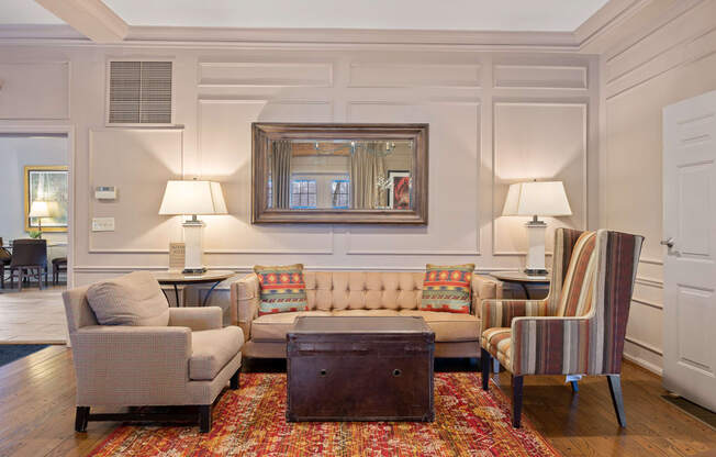 a living room with couches chairs and a table