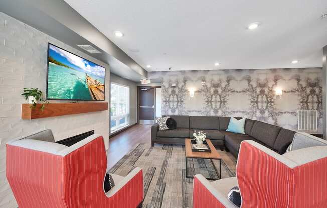 A modern living room with a flat screen TV mounted on a brick wall.