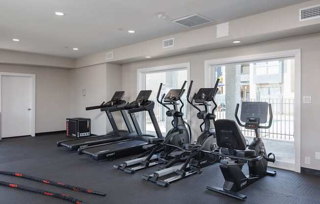 A spacious gym with treadmills, elliptical machines, and other exercise equipment.