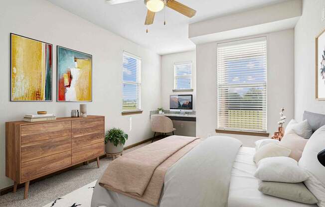 Pet-Friendly Rentals in Bentonville, AR – Parc at Bentonville – A bedroom with a bed, dresser, and a ceiling fan.