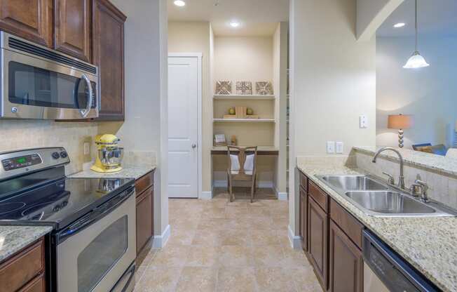 Monterra Las Colinas Apartments kitchens with stainless steel appliances and solid wood cabinets
