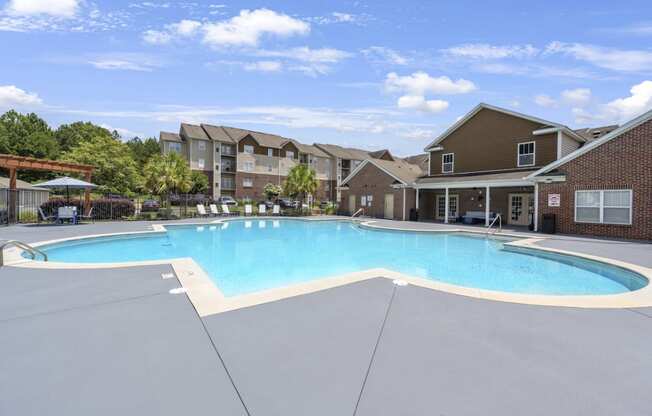 a swimming pool with an apartment building in the background