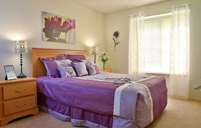 a bedroom with a bed and a dresser at Beacon Hill and Great Oaks Apartments, Rockford, IL, 61109