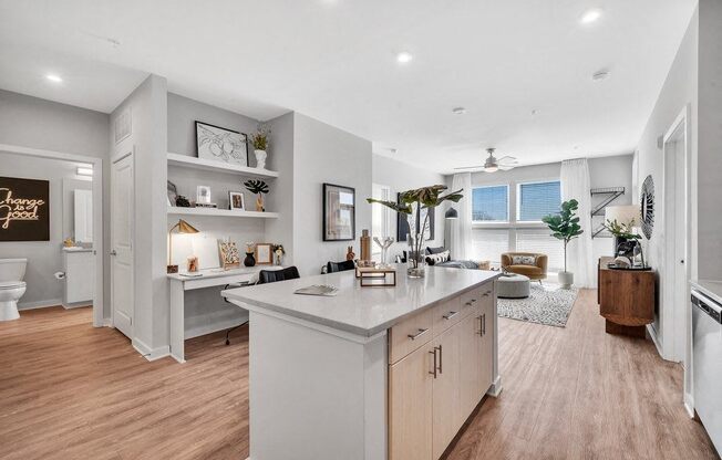 the kitchen is open to the living room and dining room