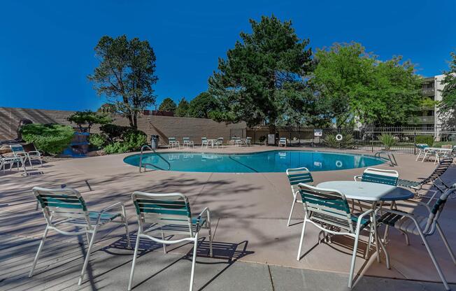 the community pool with white and blue chairs