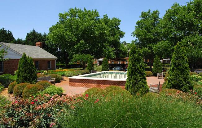 a house with bushes in front of a tree