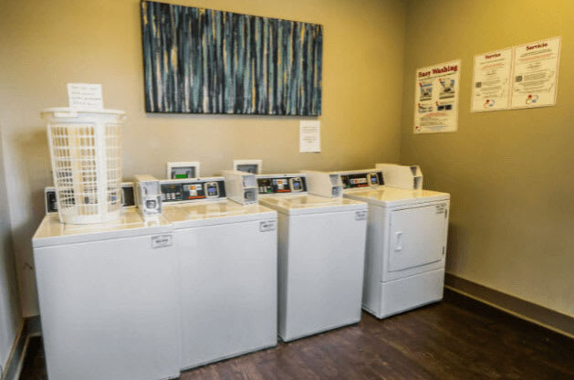 a row of washers and dryers in a room at Enclave at Breckenridge Apartments, Louisville, KY