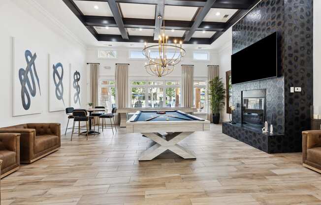 a games room with a pool table and a flat screen tv