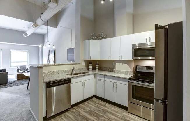 a kitchen with stainless steel appliances and white cabinets