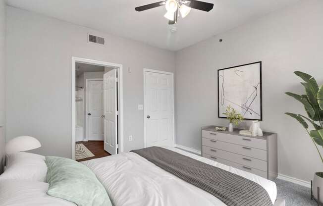 an empty bedroom with a bed and a ceiling fan