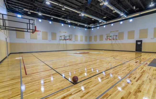 an indoor basketball court with multiple basketball hoops