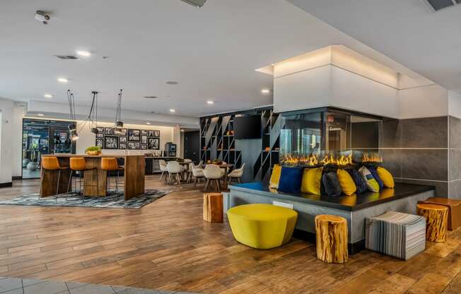 the lobby of a hotel with a bar and tables