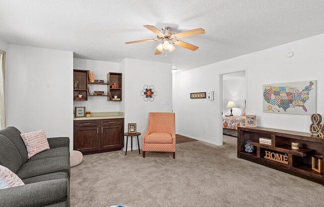 a living room with a couch and a ceiling fan