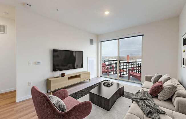 A living room with a red chair and a television.