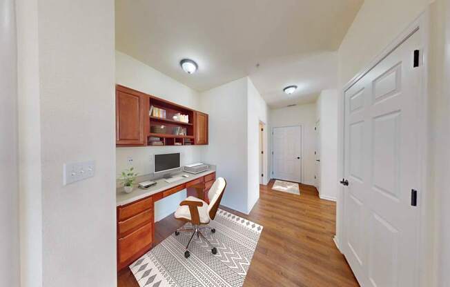 A home office with a desk, chair, and computer.