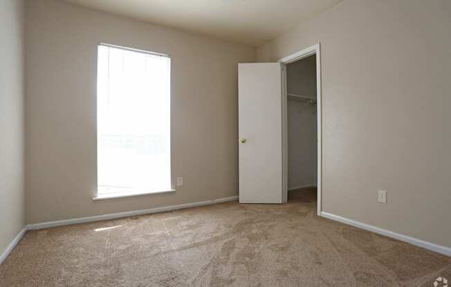 bedroom with window and closet