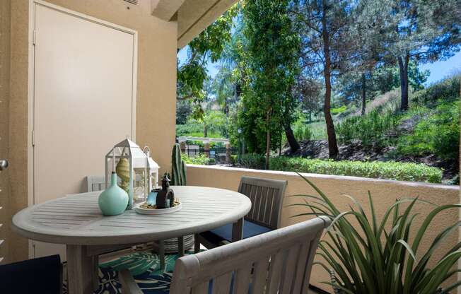 a patio with a white table and chairs