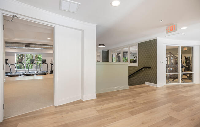 A room with a wooden floor and a green wall.