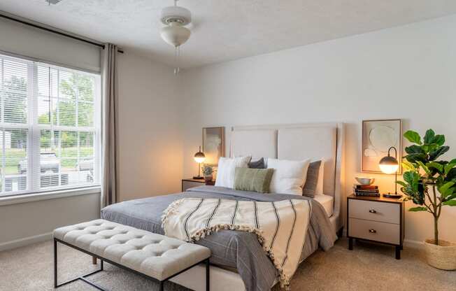 a bedroom with a bed and a curtain with grapes on it