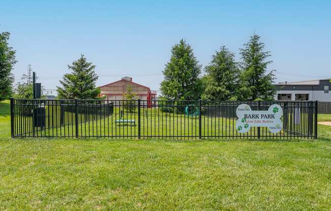 a park with a fence and a sign that reads park park