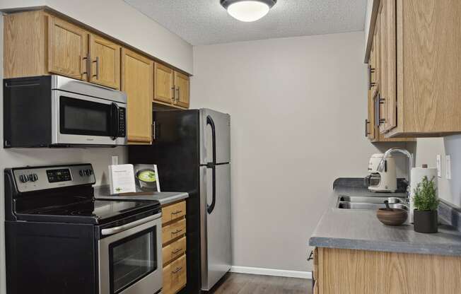 a kitchen with wooden cabinets and stainless steel appliances