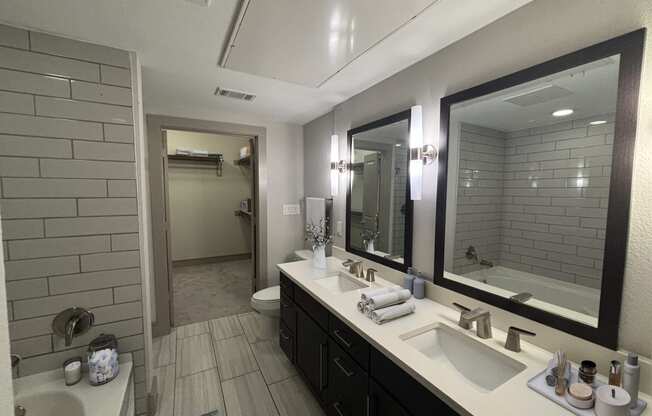 a bathroom with two sinks and a large mirror