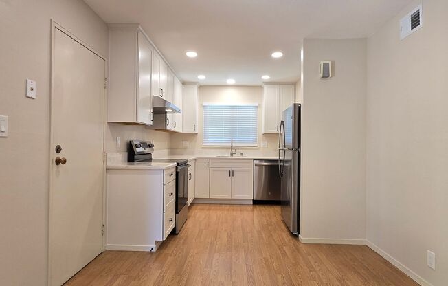 Renovated Home with New Kitchen, Stainless Steel Appliances, Wood Flooring, Fresh Paint, New Driveway, Great Location!