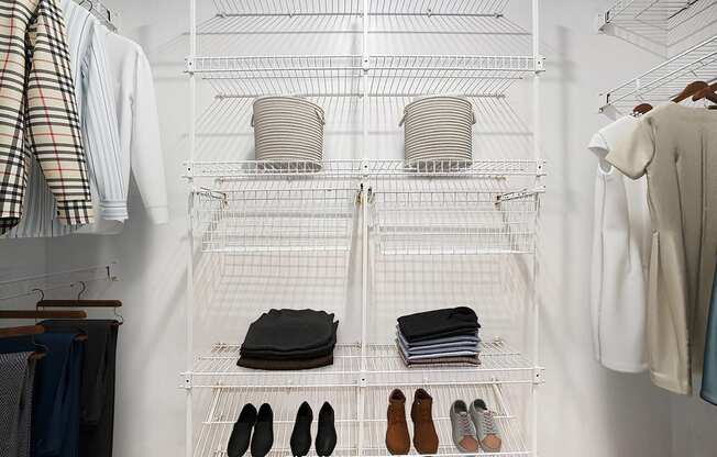 A walk in closet with wardrobe organizers at West Hampton Park Apartments in Elkhorn, NE 68022