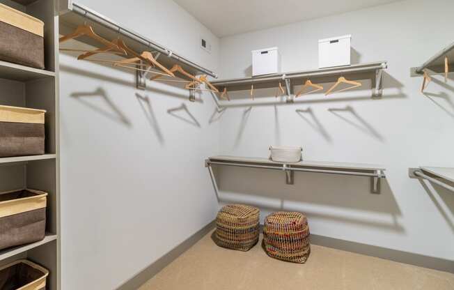 a spacious walk in closet with shelves and hangers