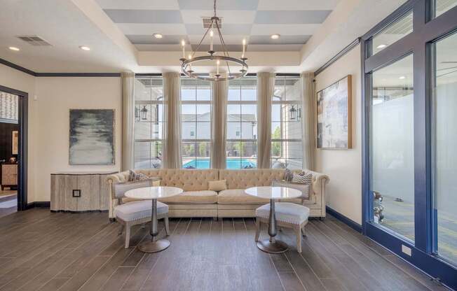 A modern living room with a large sofa and a chandelier.
