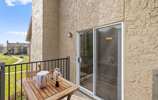 a patio with a table and a sliding glass door