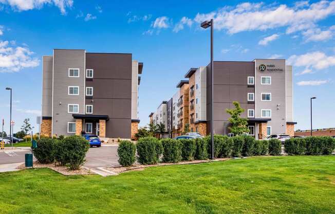 an exterior view of an apartment building with a parking lot at Parks Residential - Denver, Centennial, CO