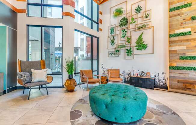 a living room with a turquoise ottoman in the center of it at Metro Gateway, California