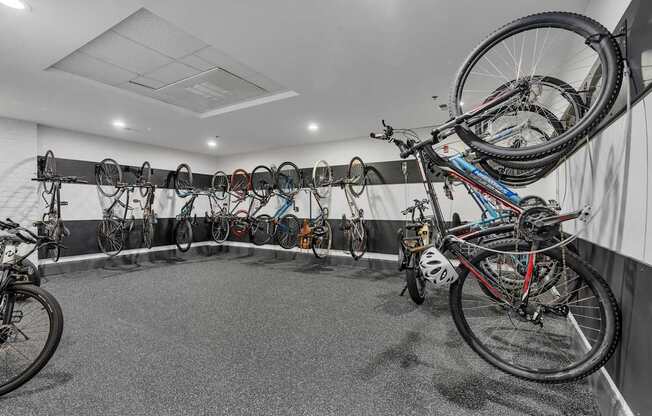 A bike shop with many bikes hanging on the wall.