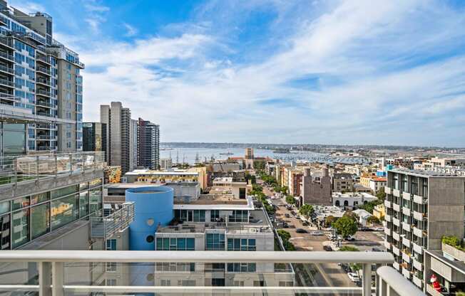 the view of the city from the balcony of an apartment building