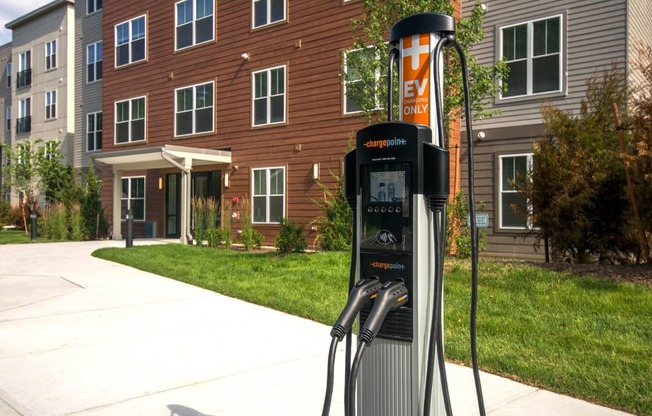 a gas pump in front of an apartment building