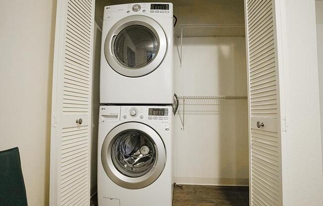 A white washing machine is in a small room.