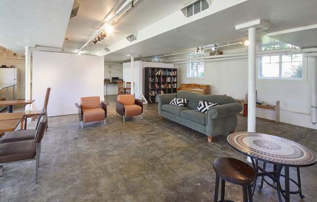 Living room with a couch chairs and a table at MILEPOST 5 Apartments, PORTLAND